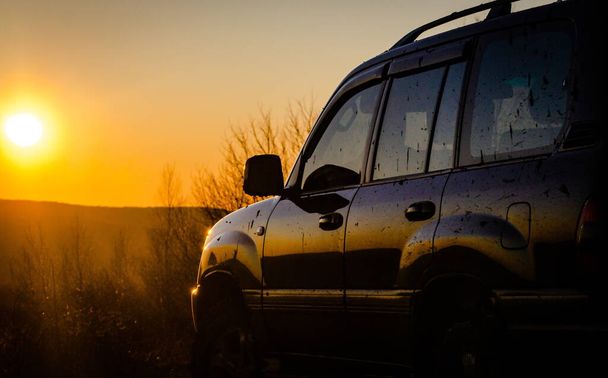 SUV podróżuje po Karpatach o zachodzie słońca - Zdjęcie, obraz