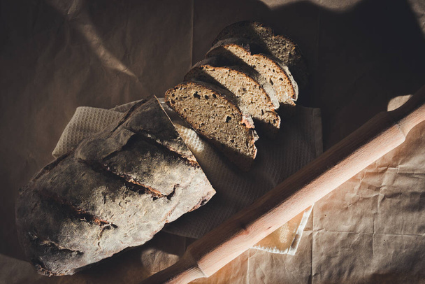 Sliced rye bread cooked with nuts and cereals inside on a close-up on the table - Fotografie, Obrázek