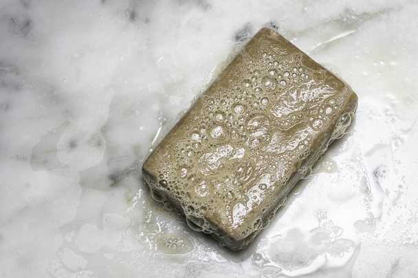 Bar of soap with bubbles Maintain hygiene and personal care with soap and water - Fotó, kép