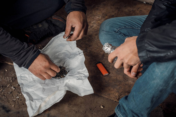 dos hombres miserables que preparan la inyección de drogas en los barrios pobres. - Foto, Imagen