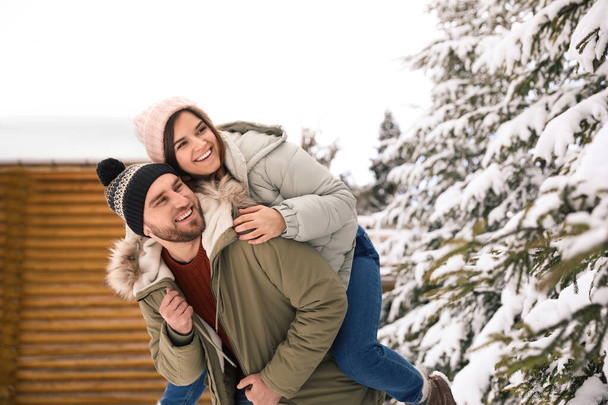 Happy couple spending time together on snowy day. Winter vacation - Foto, imagen