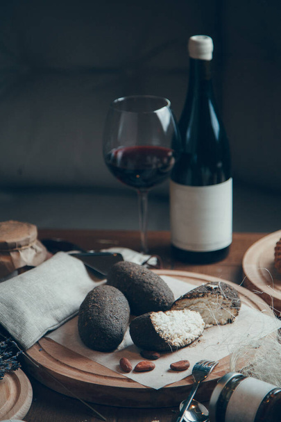 Cheese composition with wine and glass. Dried goat's cheese in balls with pepper.  - Valokuva, kuva