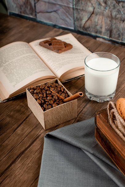 Coffee beans, a glass of milk and a book - Photo, image