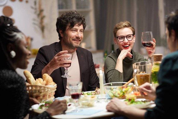Freunde trinken Wein am Tisch - Foto, Bild