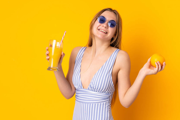 Teenager Ukrainian girl in swimsuit and holding a cocktail - Fotó, kép