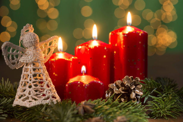 rode adventskaarsen op de oude houten achtergrond met kerstmis licht gordijn - Foto, afbeelding