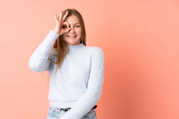 Teenager Ukrainian girl isolated on pink background showing ok sign with fingers - Φωτογραφία, εικόνα