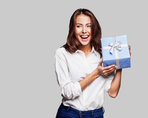 Young beautiful woman with gift  in studio - Photo, Image