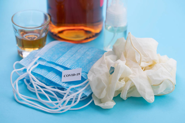 medical mask, gloves, alcohol and disinfectant on blue background - Photo, image
