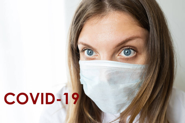 Close up of a female nurse putting on a mask to protect from airborne respiratory diseases such as the flu, coronavirus, ebola, TB, etc copyspace - Valokuva, kuva