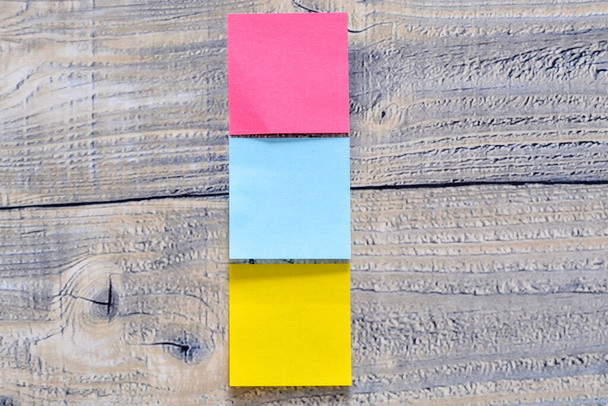 Three post its on a wooden background - Photo, Image