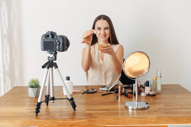 Young attractive woman records makeup tutorial - Fotó, kép