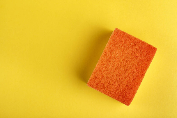 new bright wash sponge on a yellow background. place for tex - Φωτογραφία, εικόνα