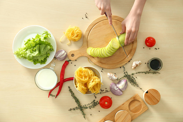 Mulher cozinhar comida na mesa de cozinha de madeira, flat lay
 - Foto, Imagem