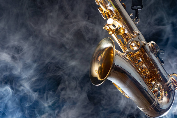Golden shiny alto saxophone on black background with smoke. copy space - Fotoğraf, Görsel