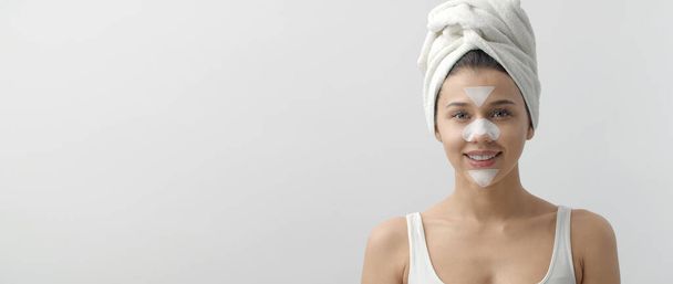 Young female using facial patches - Foto, imagen