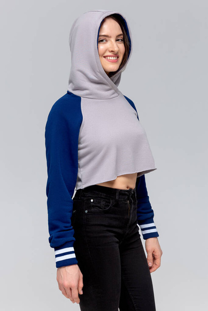 Woman in blue and gray mini hoodie, mockup for logo or branding design - Fotó, kép