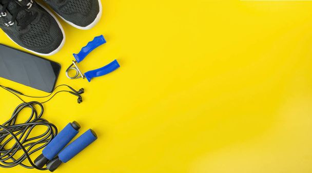 Healthy lifestyle. Sports equipment on a yellow background. Sport concept. The apartment was lying. Top view with copy space. Banner. - Photo, Image