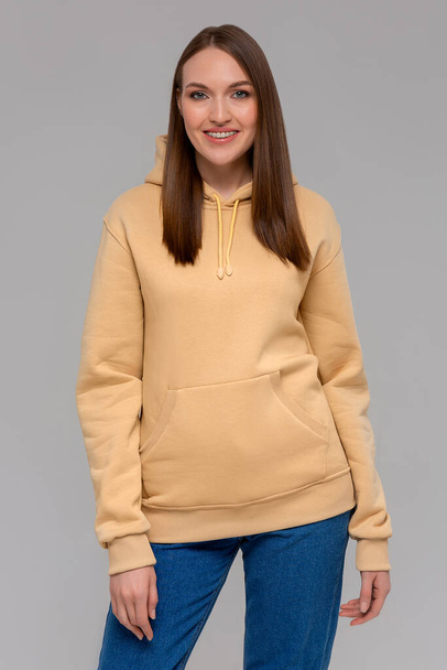Woman in gold hoodie, mockup for logo or branding design - Фото, изображение