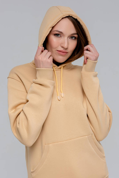 Woman in gold hoodie, mockup for logo or branding design - Fotó, kép