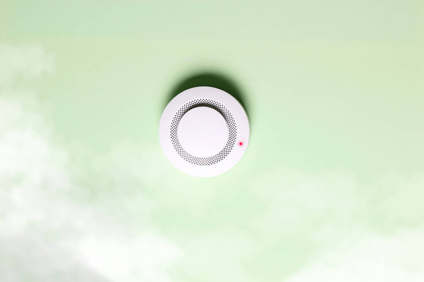 fire alarm sensor on a green light background - Foto, imagen