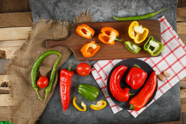 Variety of colorful peppers in a rustic space. - Photo, Image