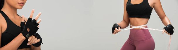 Aziatisch tan huid fitness vrouw oefening punch lucht slijtage bokshandschoenen zwart sport beha moerbei paarse broek, studio verlichting grijs achtergrond kopiëren ruimte, concept verlies gewicht meetlint taille - Foto, afbeelding