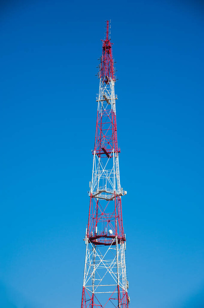 Radio tower with nature. Telecommunication tower with antennas on blue sky background - Photo, Image