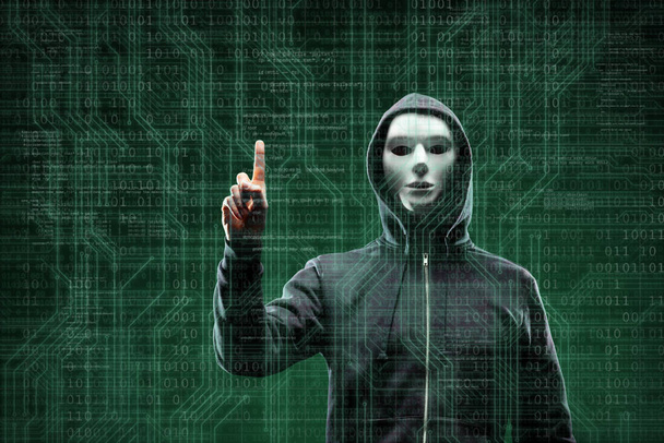 Computer hacker in mask and hoodie over abstract binary background. Obscured dark face. Data thief, internet fraud, darknet and cyber security concept. - Fotoğraf, Görsel