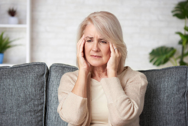 Sad senior woman having headache. Old lady is sick. - Foto, afbeelding