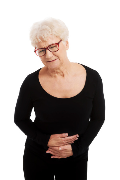 An old lady is having a stomachache. - Fotó, kép