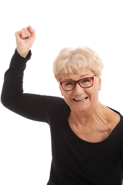 Happy old woman having closed fists. - Zdjęcie, obraz