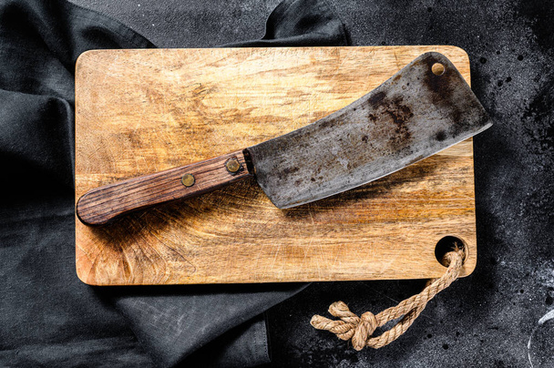 Vintage butcher meat cleaver on concrete board. Black background. Top view. - Photo, Image