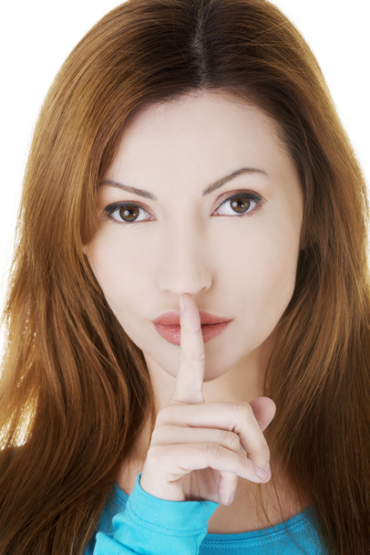 Portrait of casual woman with finger on lips. - Foto, Imagen