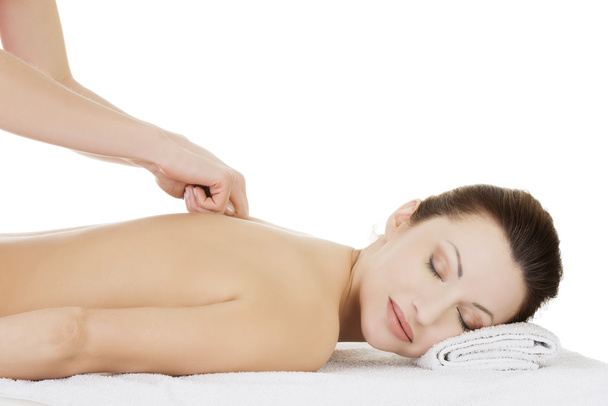 Preaty woman relaxing being massaged in spa saloon. - 写真・画像