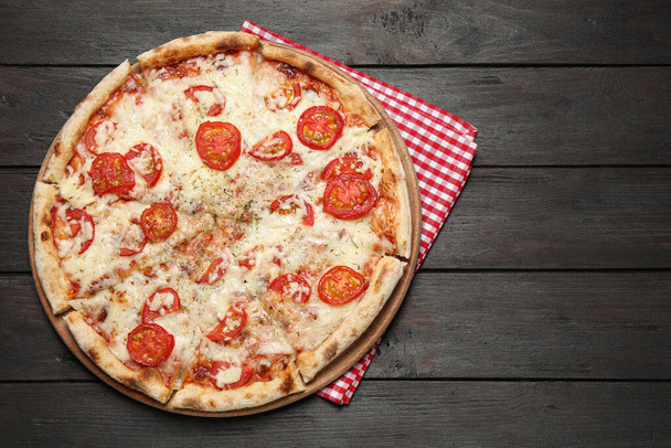 Delicious pizza Margherita on wooden table, top view - Foto, imagen
