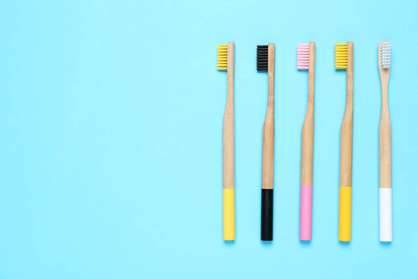 Toothbrushes on light blue background, flat lay. Space for text - Photo, Image