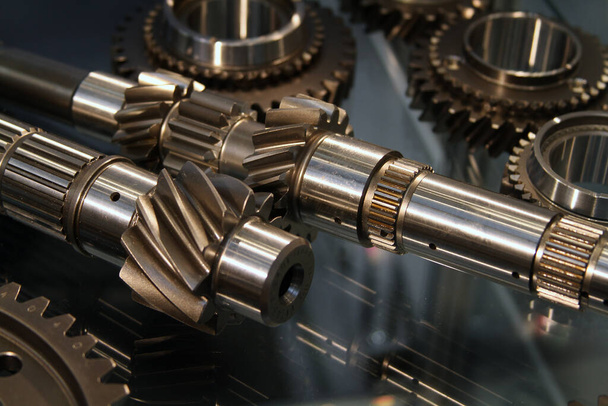 Angle cut teeth on gear cogs fitted to drive shaft. High performance modern vehicle parts. - Photo, Image