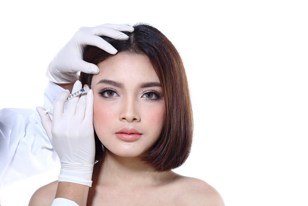 Beautiful Asian woman want to check eye, nose, eyebrow, forehead, cheek, jawline before plastic surgery, studio lighting white background copy space for text logo - Photo, Image