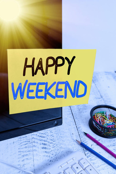 Text sign showing Happy Weekend. Conceptual photo something nice has happened or they feel satisfied with life Note paper taped to black computer screen near keyboard and stationary. - Photo, Image