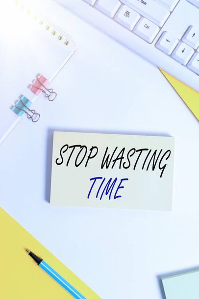 Writing note showing Stop Wasting Time. Business photo showcasing advising demonstrating or group start planning and use it wisely Flat lay with pc keyboard and copy space for text messages. - Photo, Image