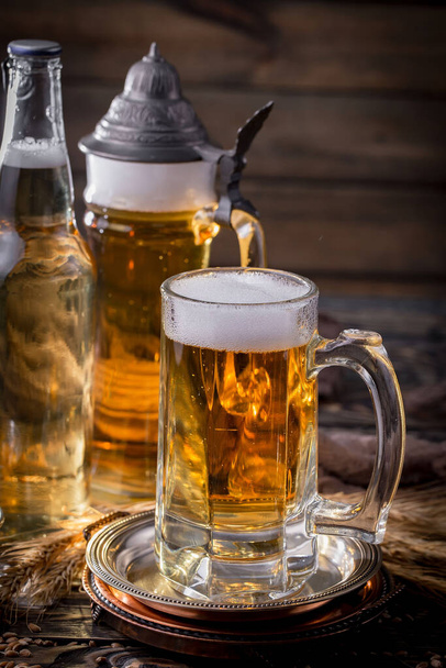 Light beer in a glass, on an old background. - Foto, afbeelding