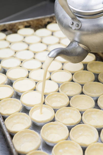 Pot filling egg pudding into puff - Photo, Image