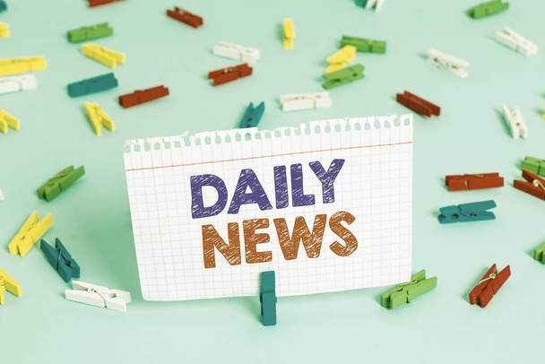 Writing note showing Daily News. Business photo showcasing information or reports about recent events published everyday Colored clothespin papers empty reminder blue floor officepin. - Photo, Image