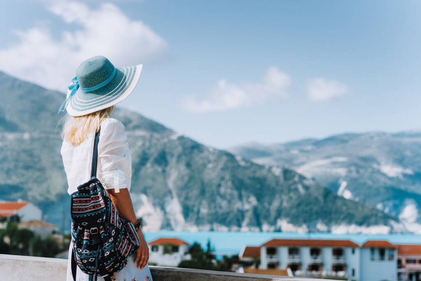 Female on holiday visiting greek Assos small town. Kefalonia, Greece. Sommer vacation vibes - 写真・画像