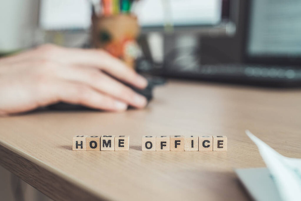 Home Office letters in foreground, man working in home office , blurry background - Фото, изображение
