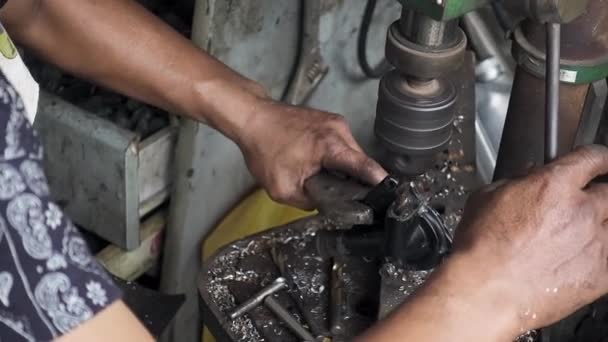 Mechaniker richten und verwenden Bohrmaschine, um irgendein Metallteil des Fahrzeugs zu bohren. Handheld-Zeitlupenaufnahme, 29.97fps. - Filmmaterial, Video