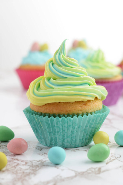 colorful yellow and blue easter swirl cupcake - Foto, Imagen