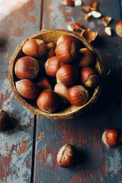 Hazelnut in  a coconut bowl, healthy superfoods, selective focus - Foto, Imagen