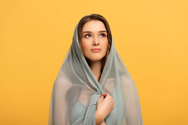 beautiful elegant smiling girl in dress and veil isolated on yellow - Фото, зображення